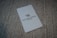 A white card with the Waldorf Astoria Las Vegas logo is placed on a textured, woven surface.