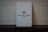 A light gray key card with the logo and text 'Waldorf Astoria Las Vegas' set against a textured woven background. The card appears minimalist and elegant.