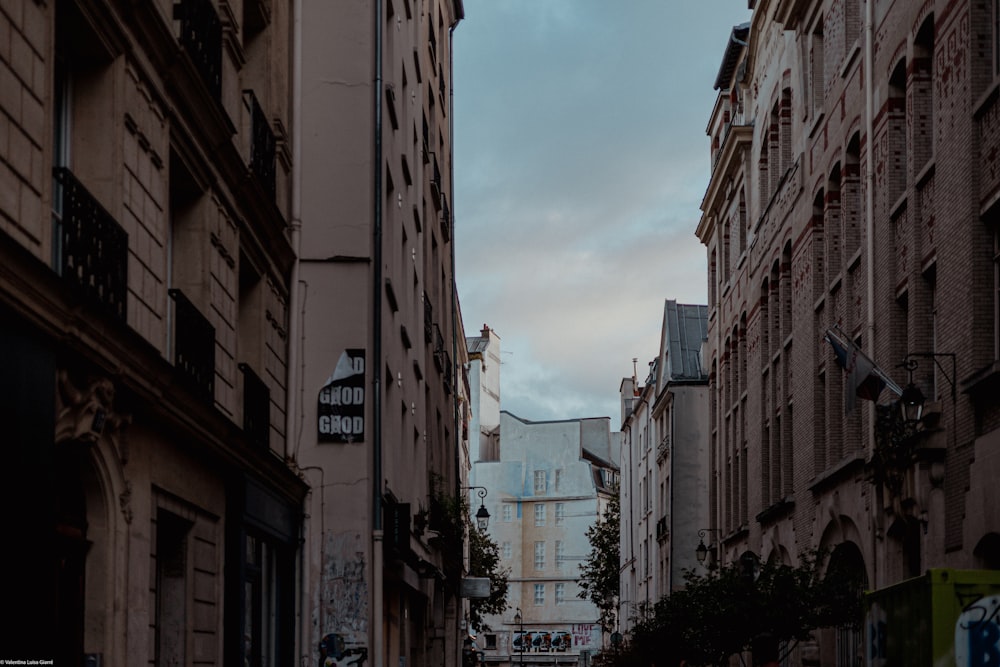 a narrow city street lined with tall buildings