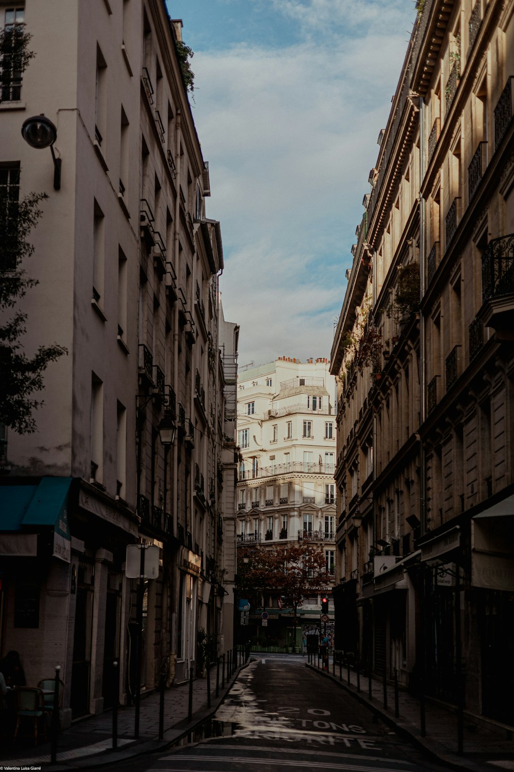 a narrow city street lined with tall buildings