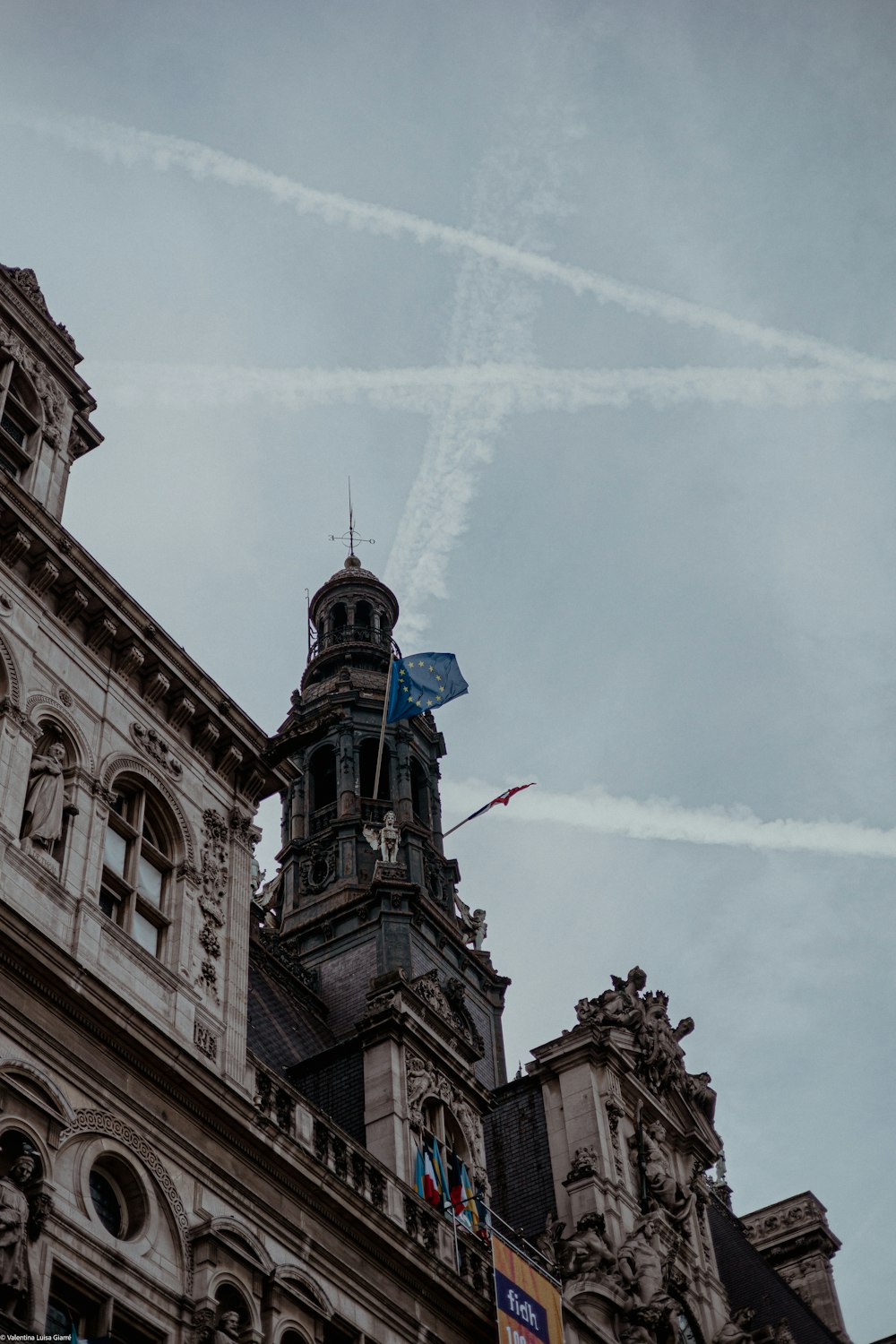 a tall building with a clock tower and a sky background