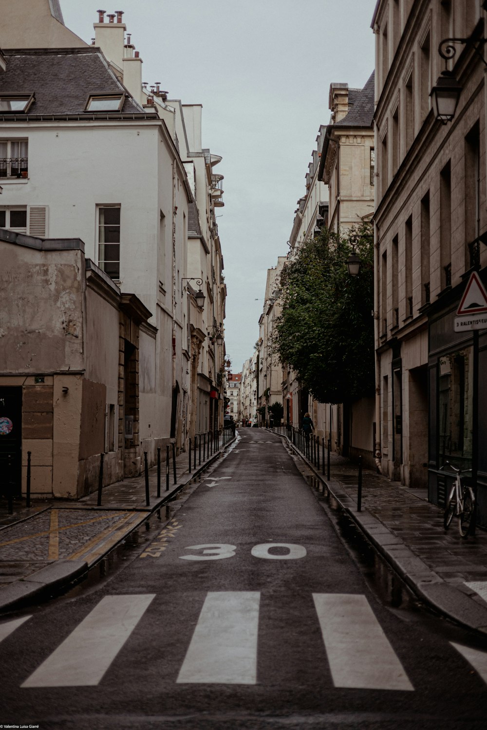 an empty city street with a crosswalk painted on it