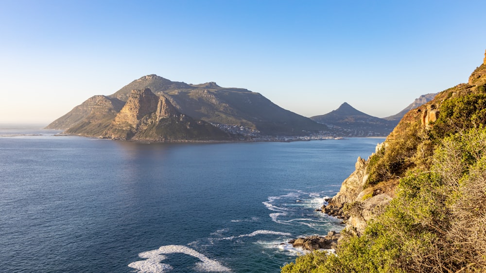 a view of a body of water with mountains in the background