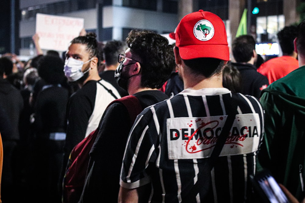 a group of people standing around each other wearing face masks