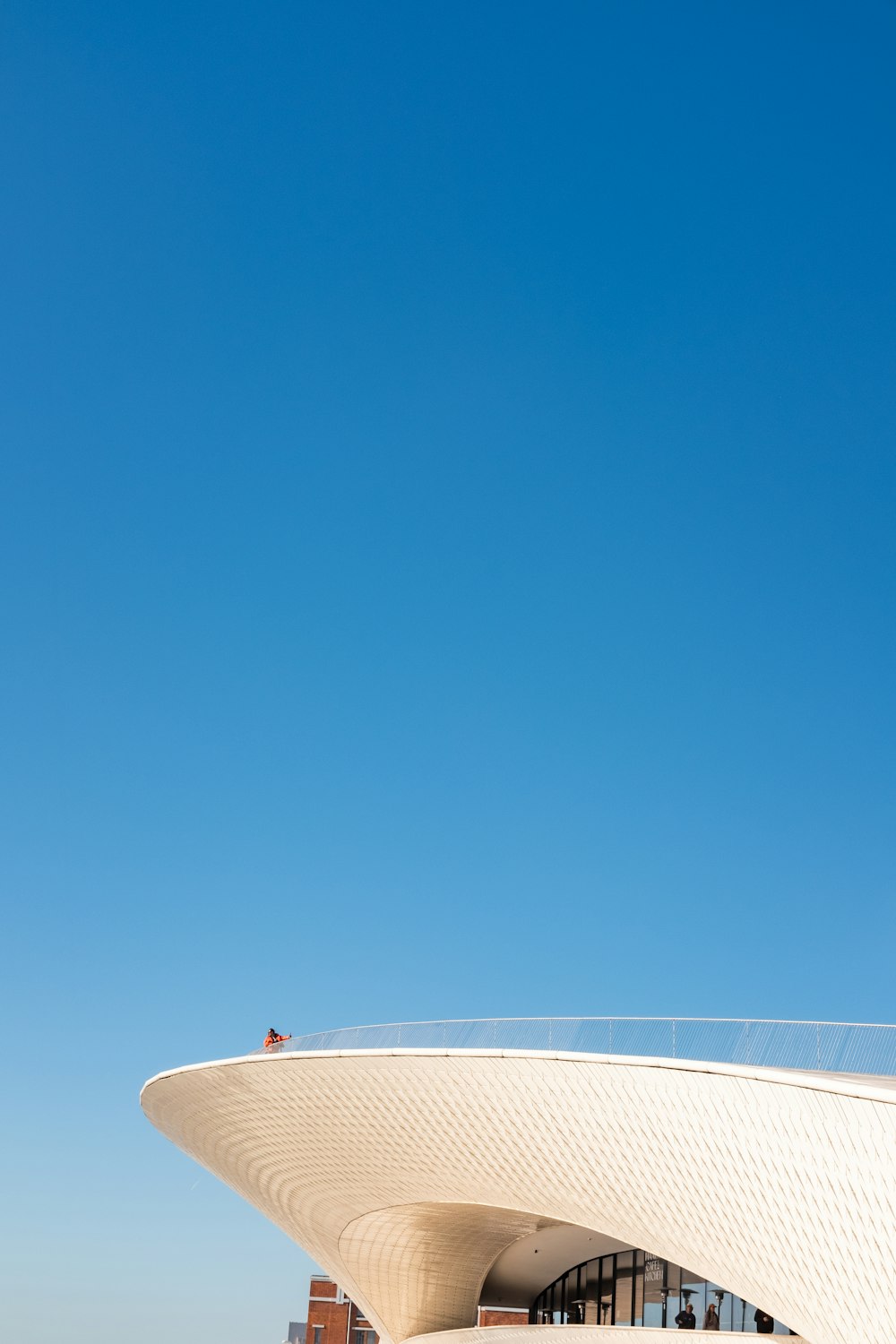 a tall white building with a sky background