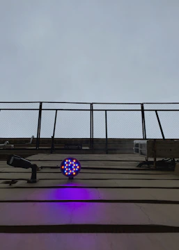 Aerial view of a critical infrastructure site secured with perimeter sensors and surveillance cameras illuminated in blue tones.