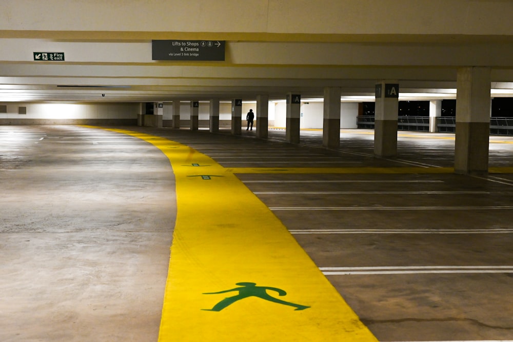 an empty parking garage with a yellow line painted on the floor