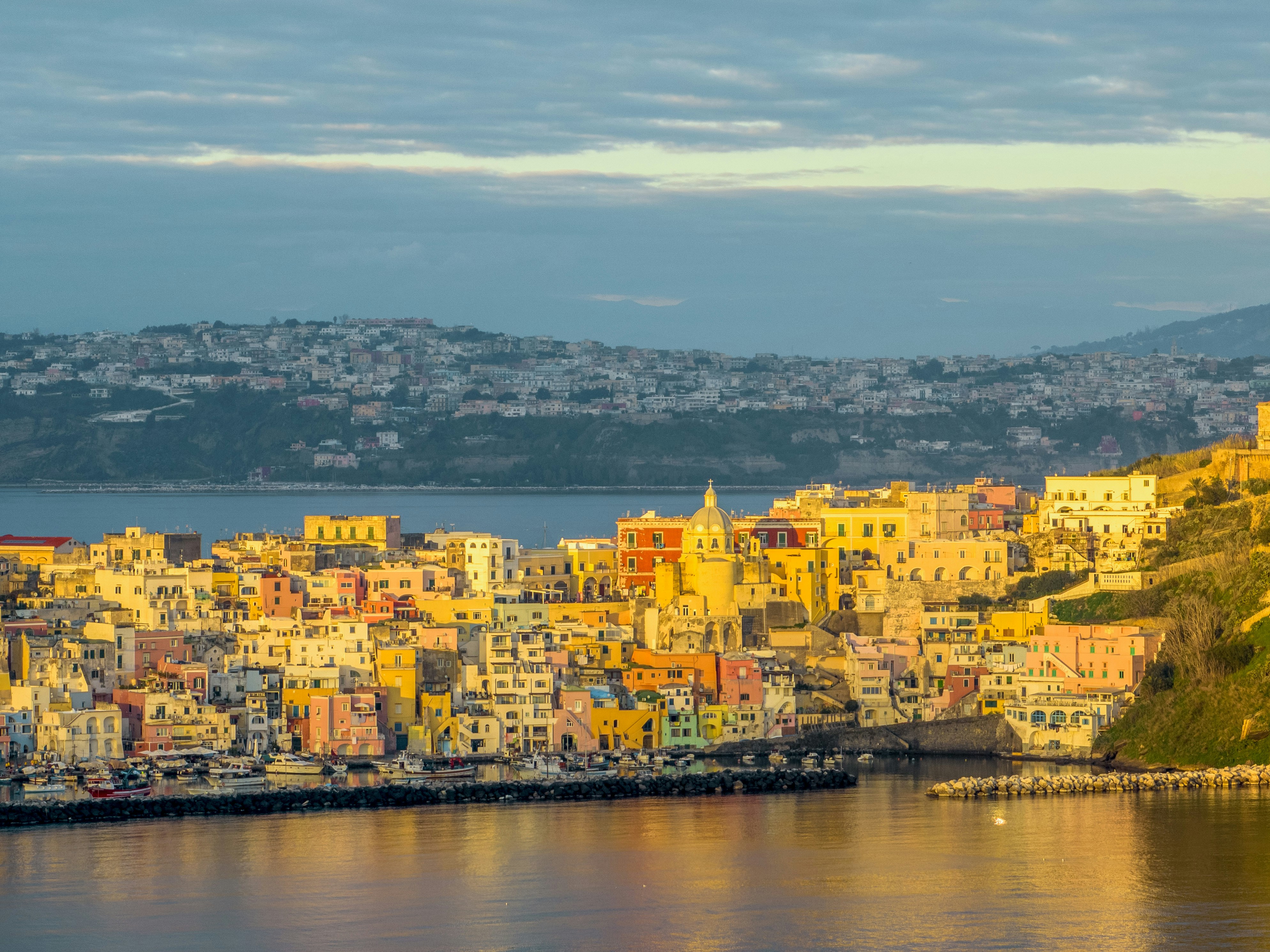 a large body of water with a city in the background
