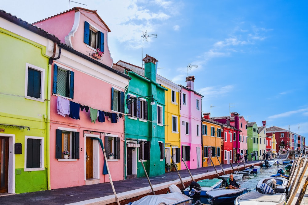 a row of colorful buildings next to a body of water