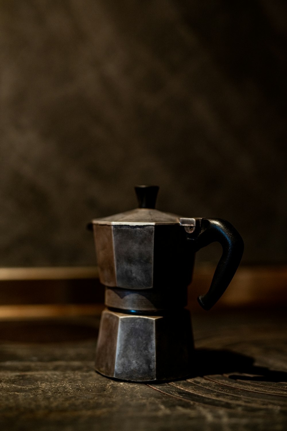 a coffee pot sitting on top of a wooden table