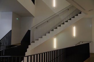 Elegant interior railing with matte black finish along a wooden staircase