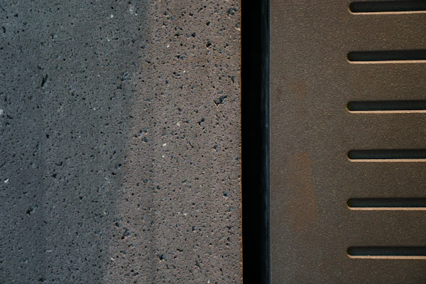 A close detail of dark textured concrete.