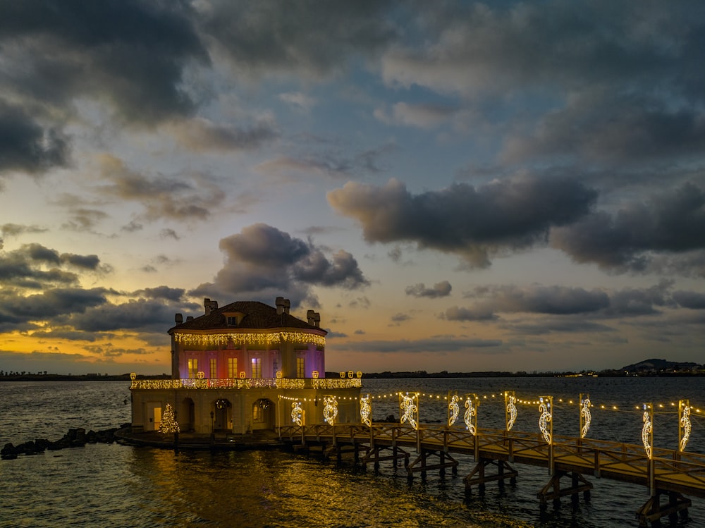 a pier with a lit up building on top of it