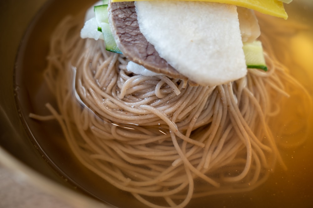 a close up of a plate of food with noodles