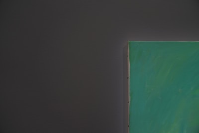 A close-up of a student painting on a canvas.