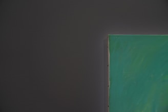 A close-up of a student painting on a canvas.