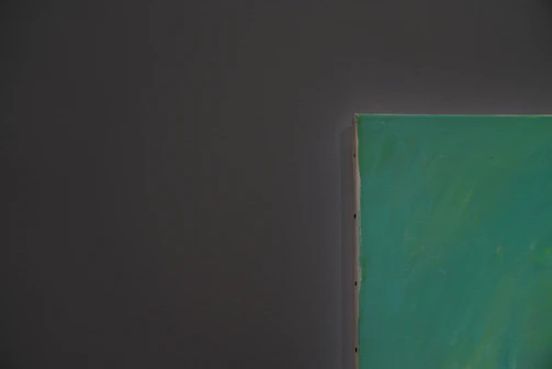 Close-up of a gold-foiled edge on a sleek black canvas print, highlighting fine texture.