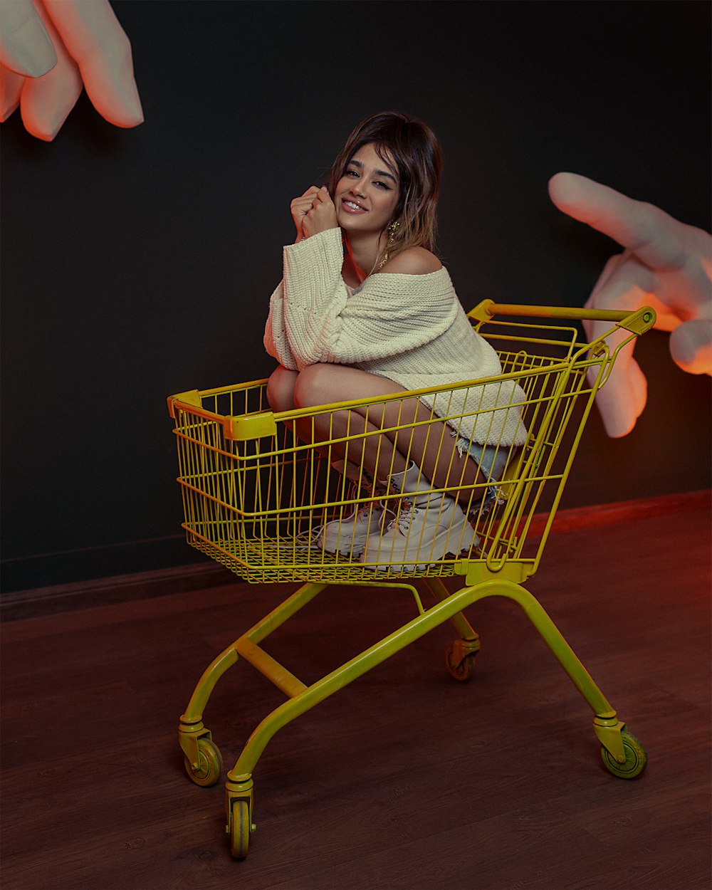 a woman sitting in a yellow shopping cart