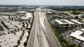 an aerial view of a highway and a city