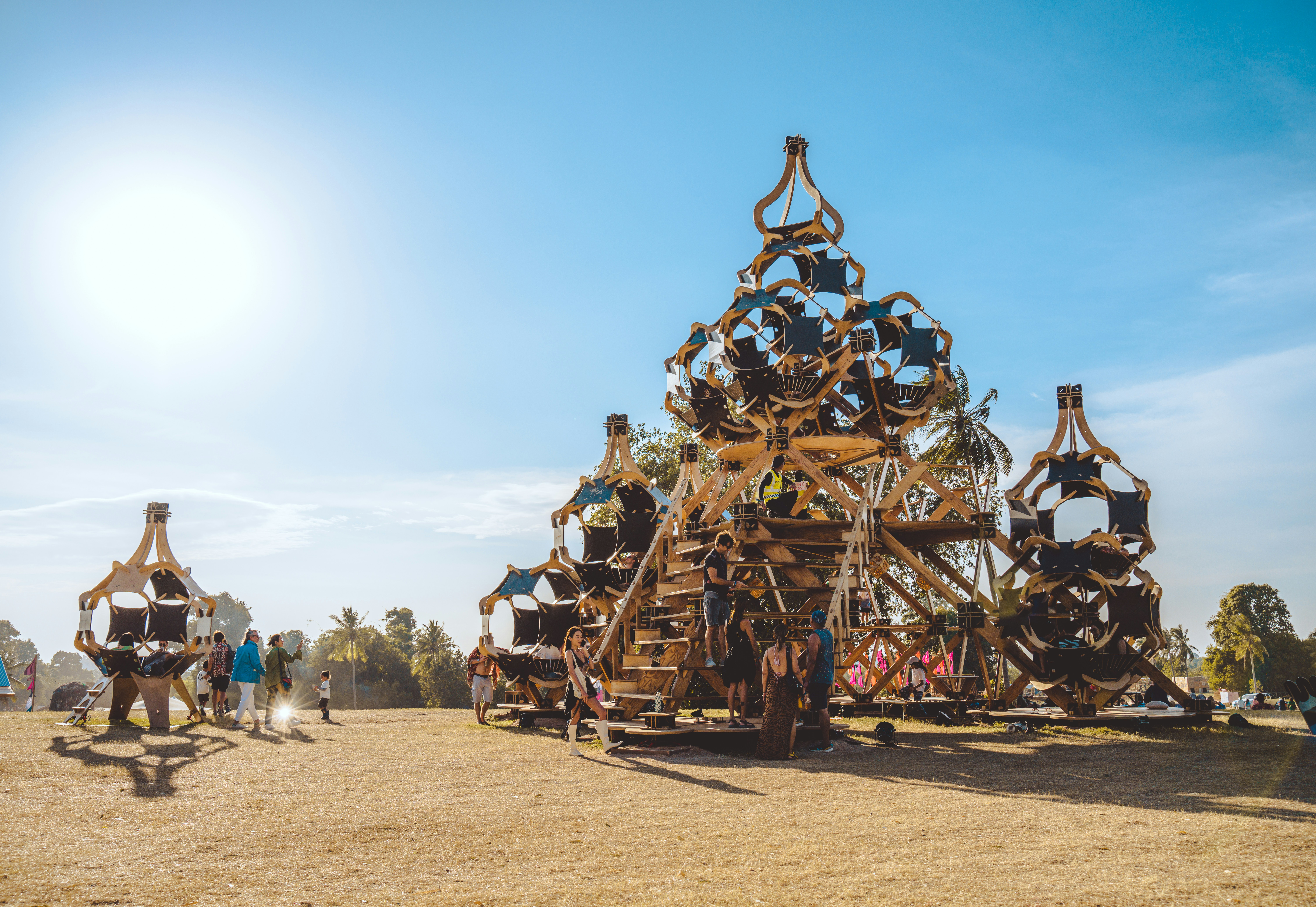 a group of people standing around a wooden structure