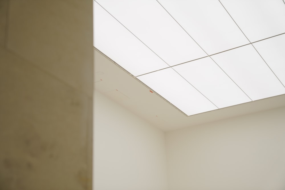 a corner of a room with a skylight above it