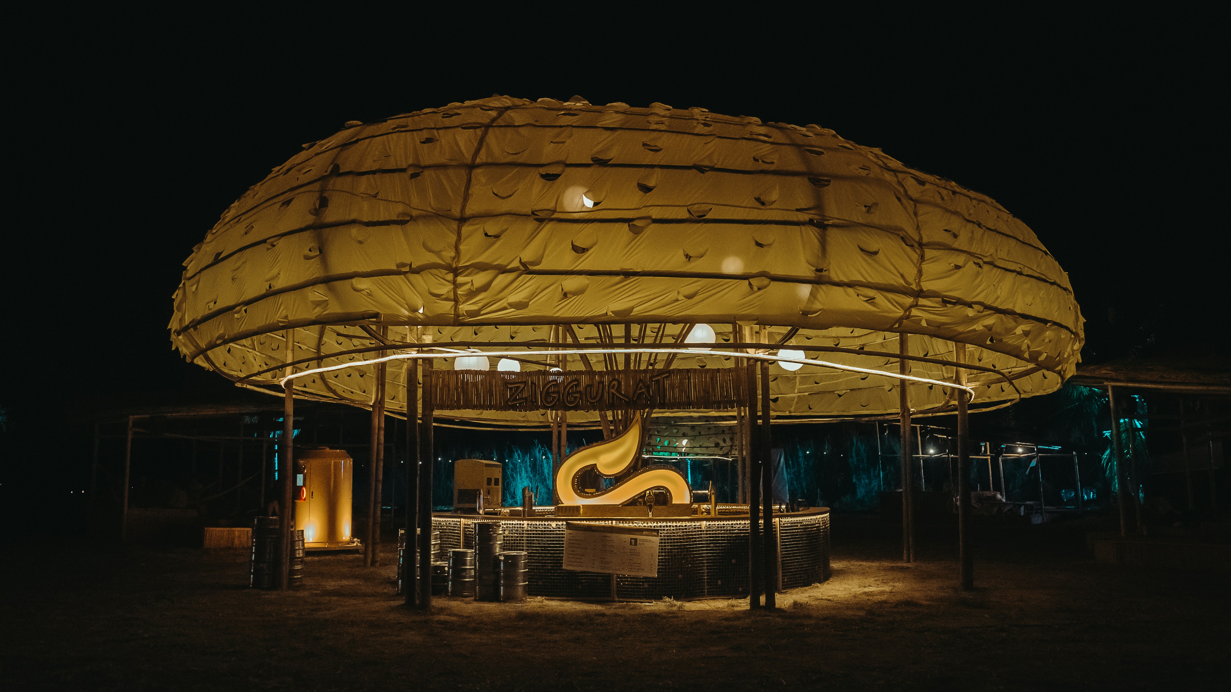 a lit up gazebo in the middle of a field at night