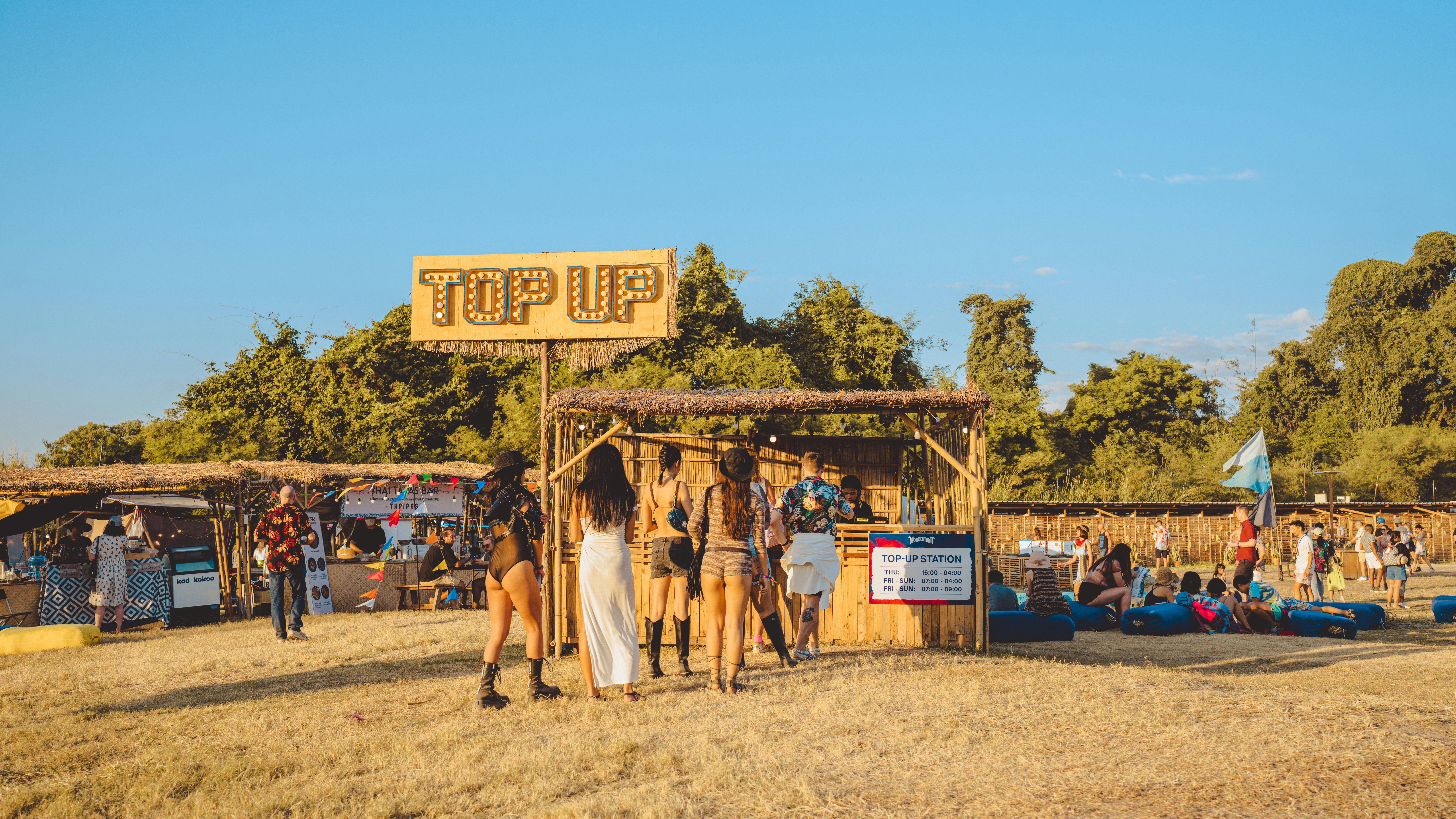a group of people standing around a wooden structure
