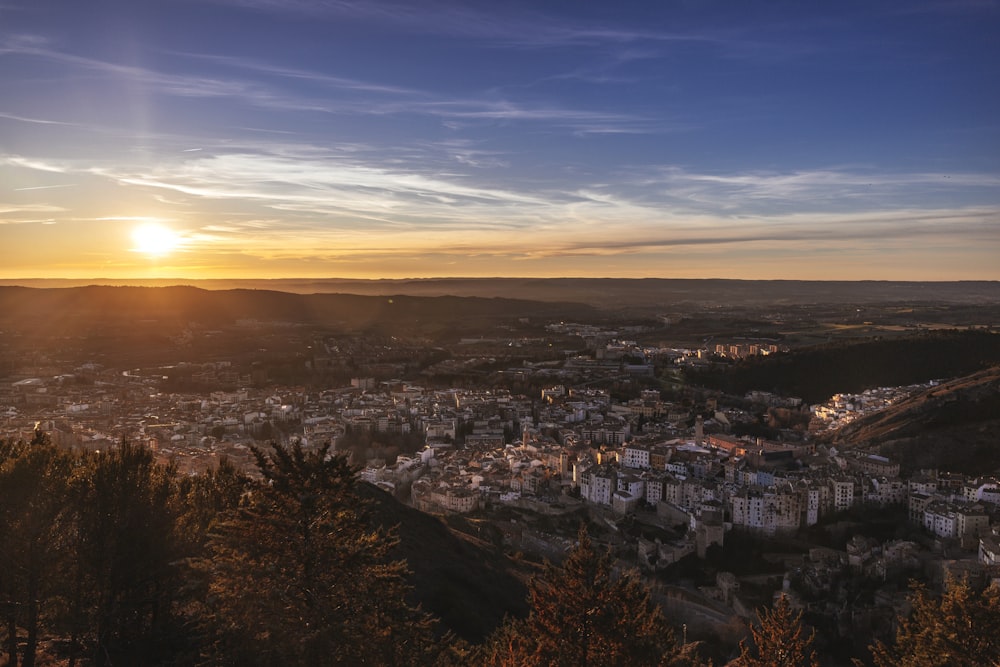 the sun is setting over a small town