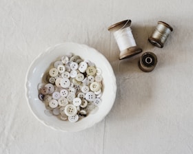 Close-up of colorful sewing trims and buttons neatly arranged on a wooden table.
