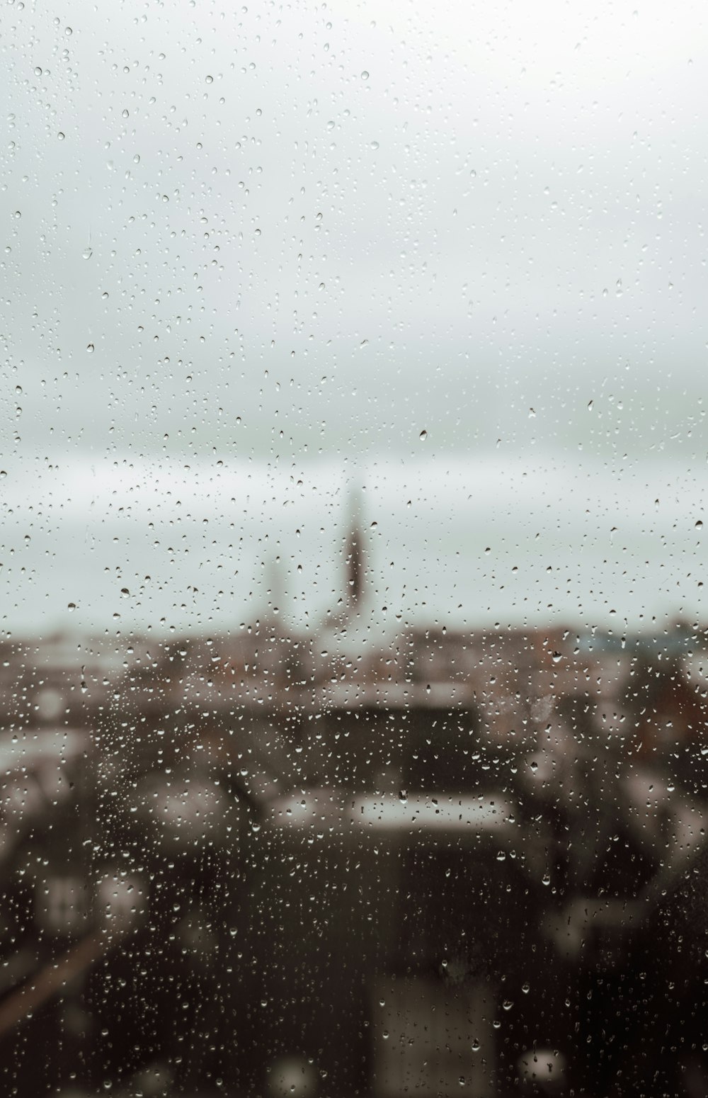 a view of a city through a rain covered window