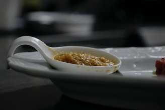 Close-up of golden pure desi ghee in a traditional clay pot with a wooden spoon