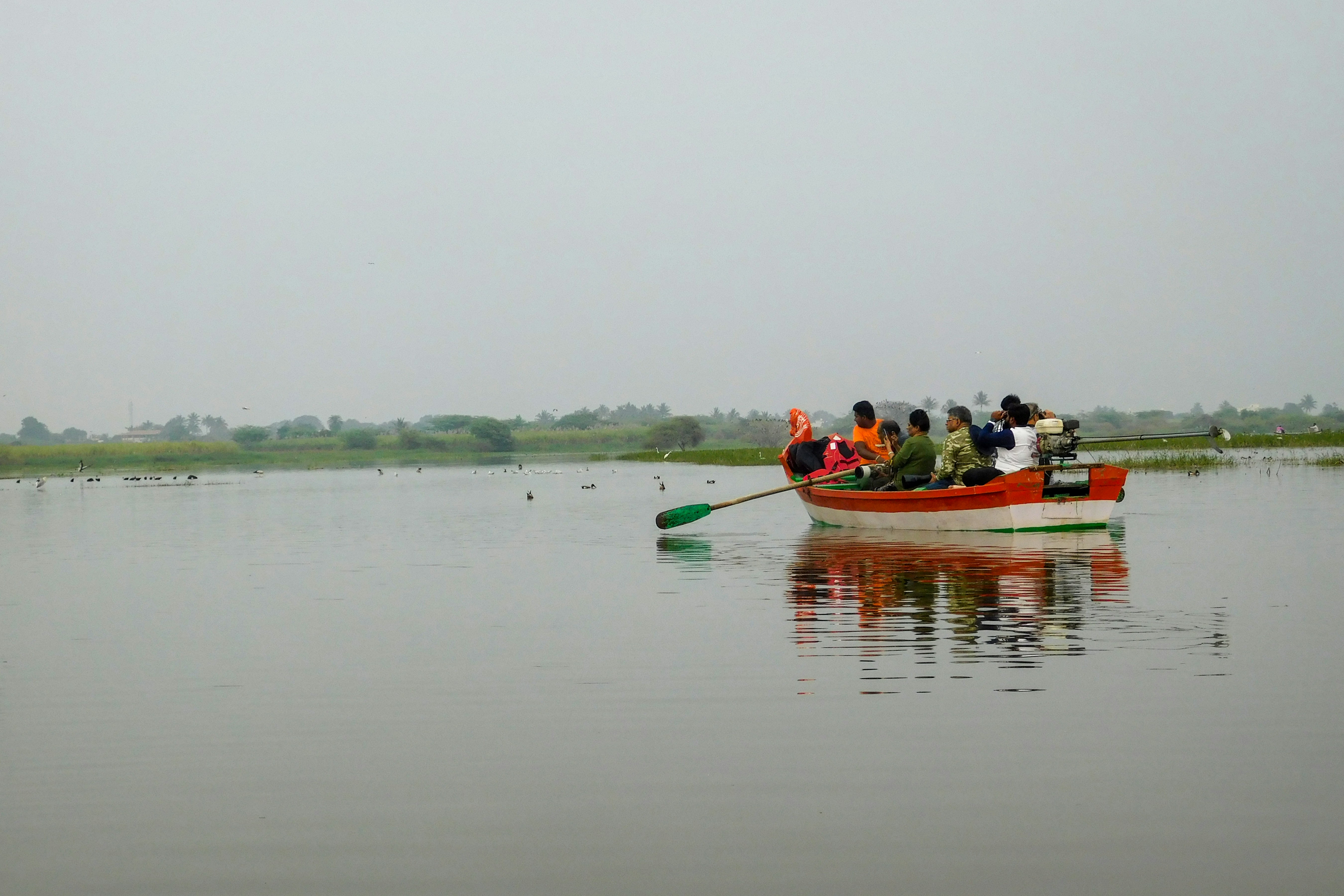 A boat full of people sightseeing at Bhigwan Bird Sanctuary in India