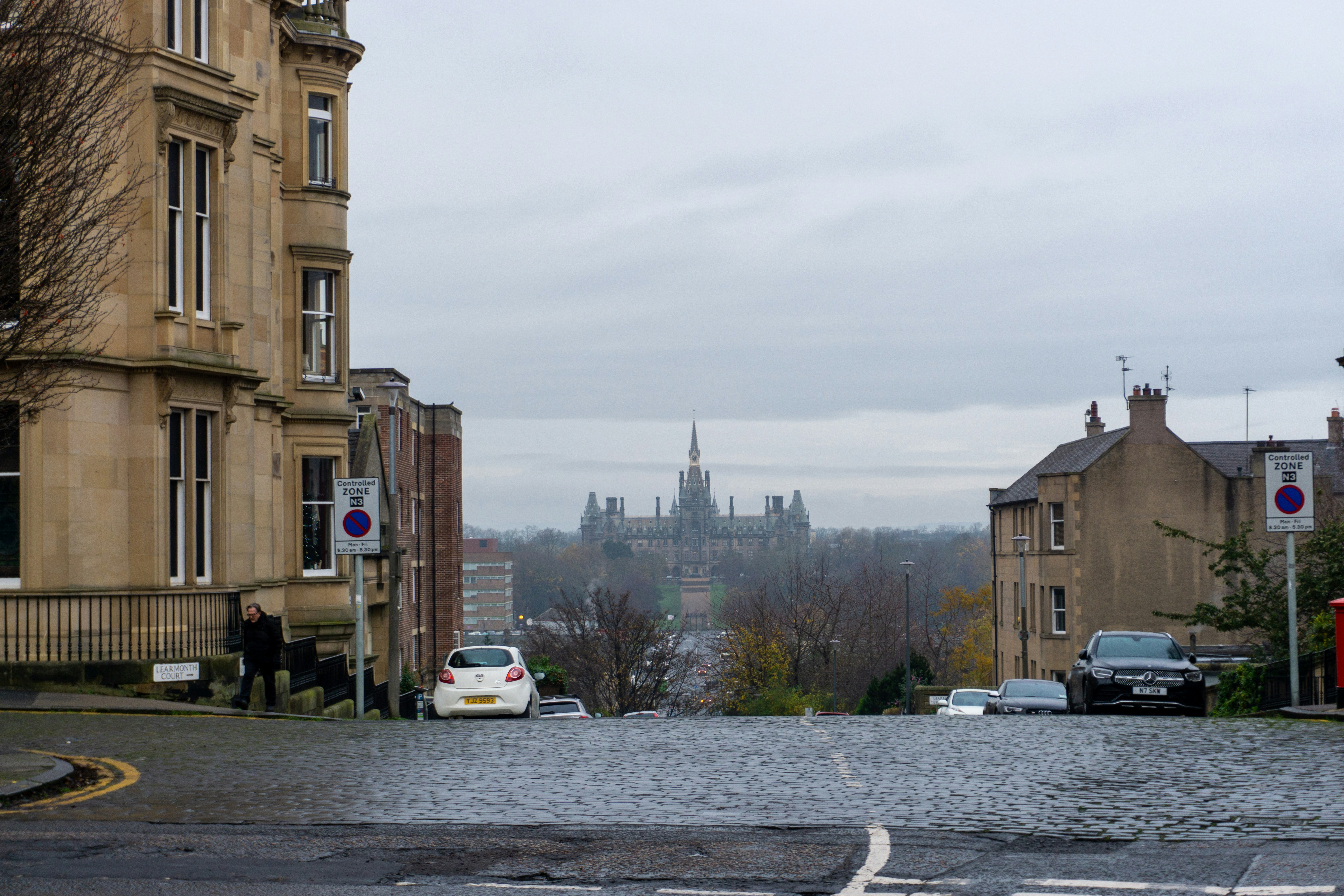 a city street with cars parked on the side of it