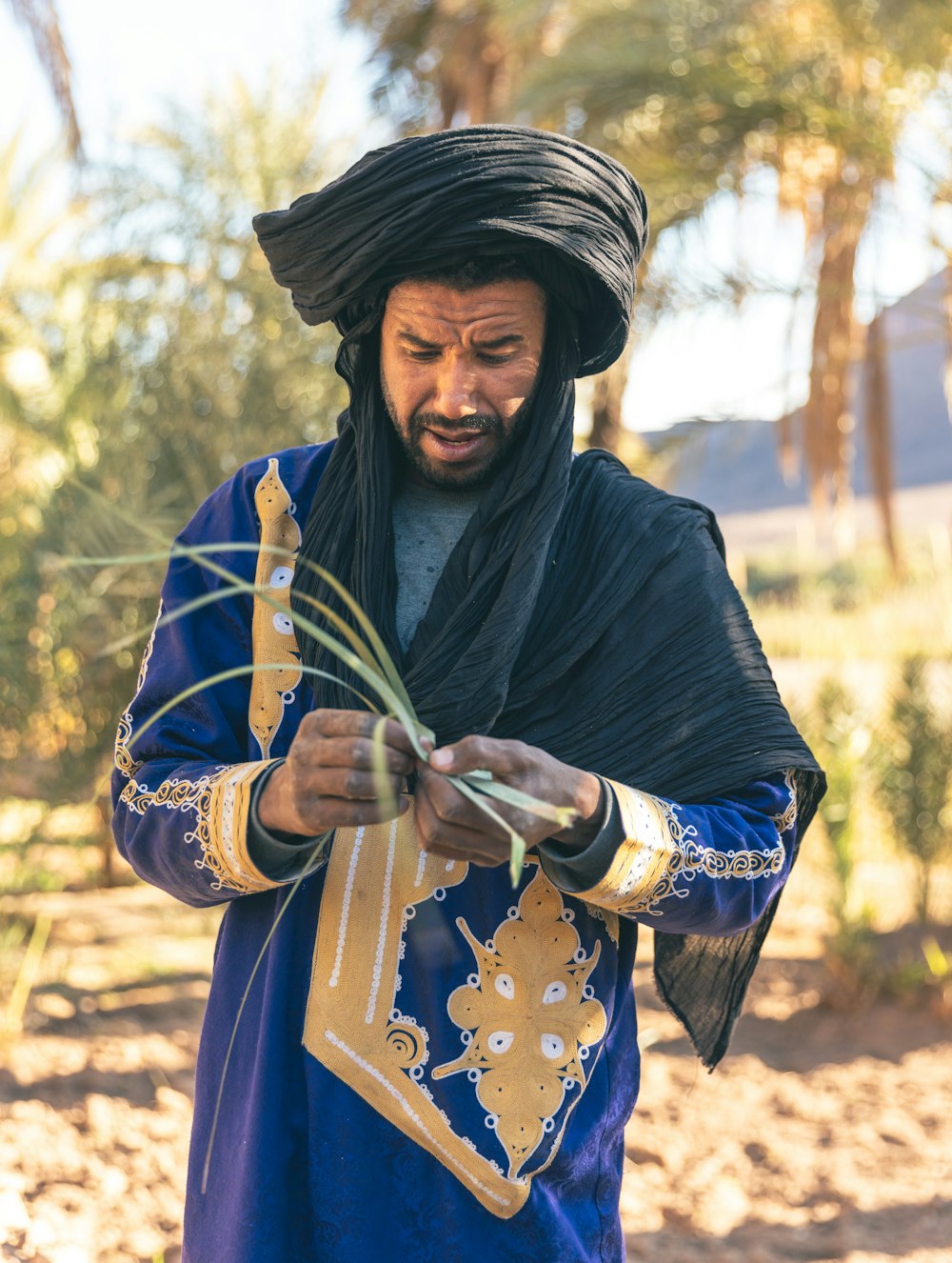 a man in a blue and black outfit holding a stick