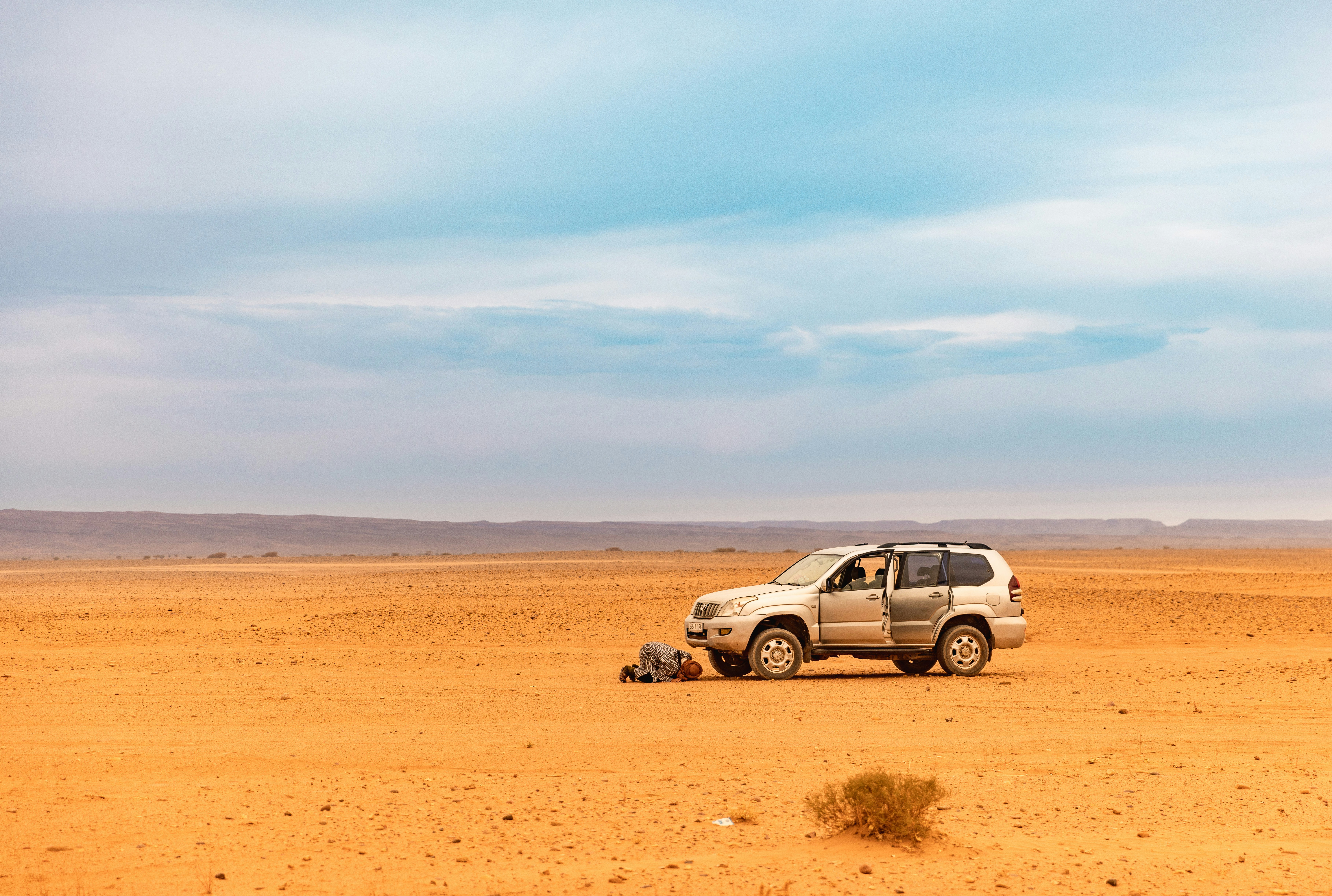 A car parked in the middle of a desert