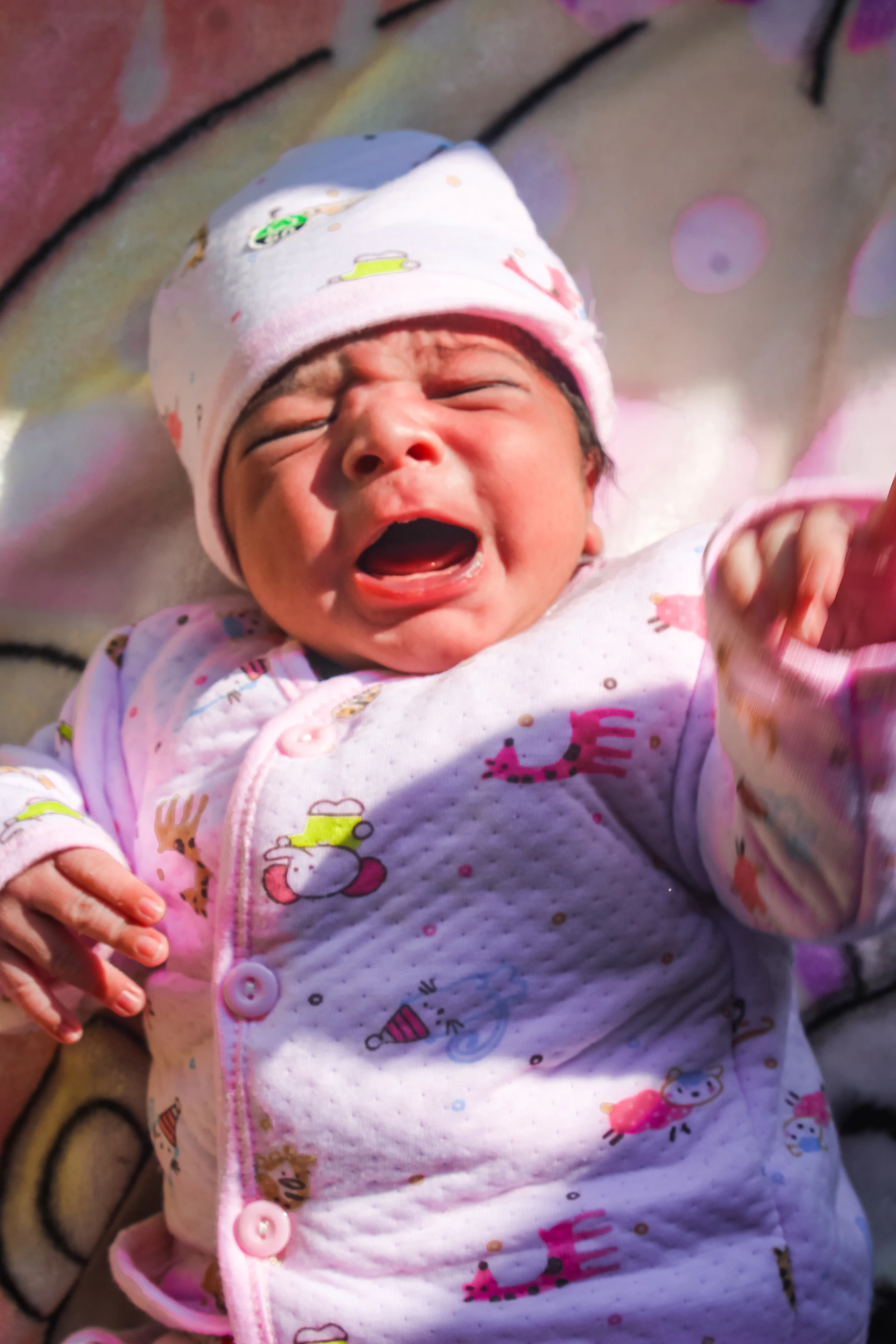 a baby crying with its mouth wide open