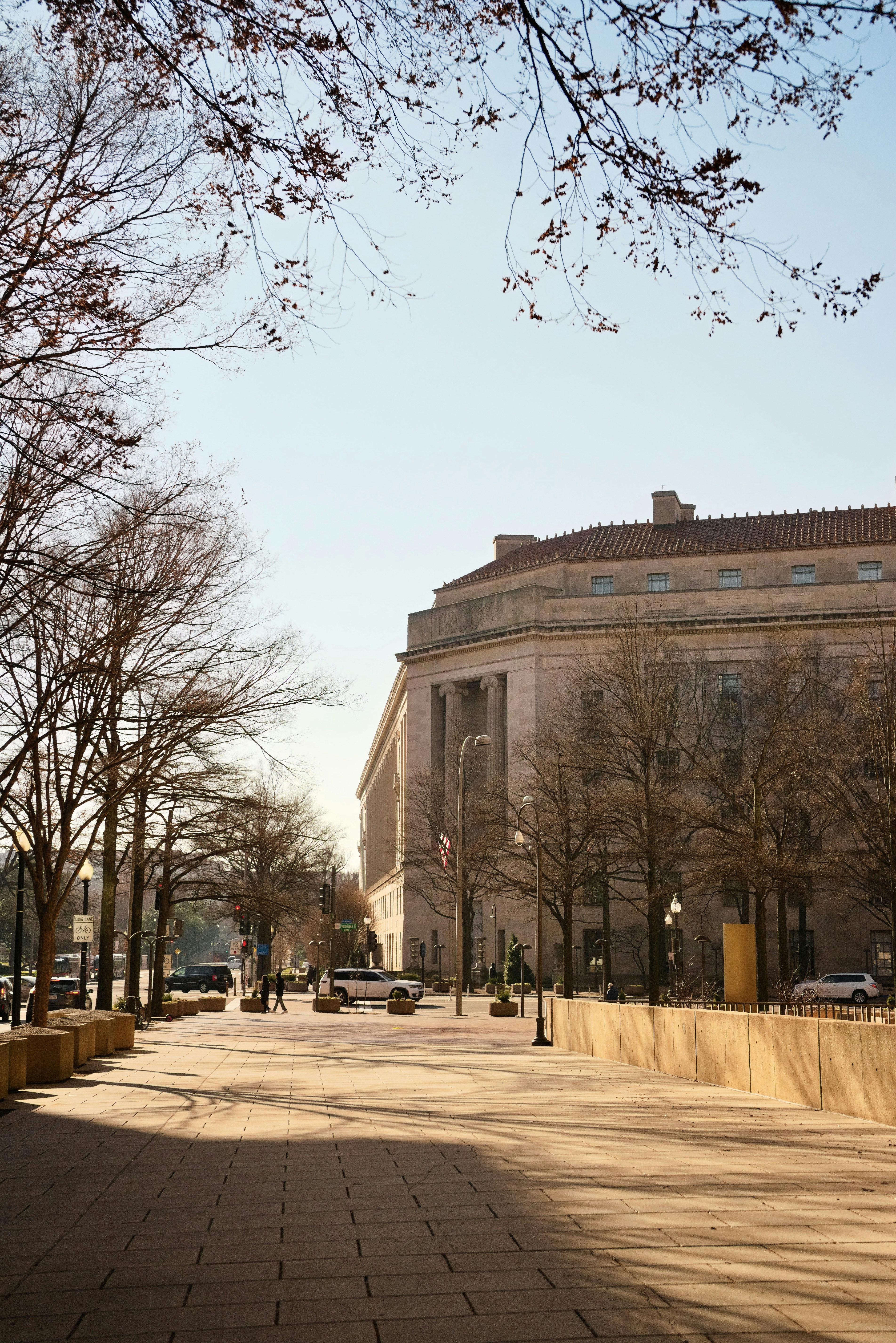 a city street with a large building in the background