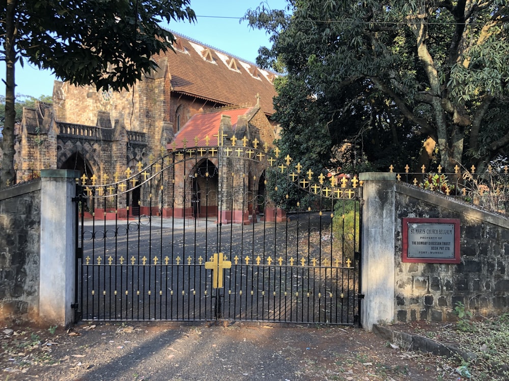 a gated entrance to a church with a yellow cross on it