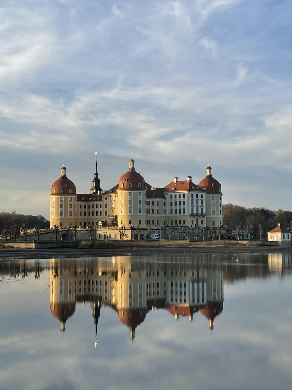 a large building sitting next to a body of water