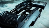 Two handguns are placed on a textured surface, one overlapping the other. The focus is on the intricate details of the gun surfaces, highlighting their metallic and textured grips.