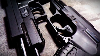 a close up of two guns on a carpet
