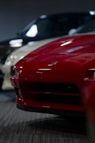 Behind-the-scenes shot of a car review video shoot with a sleek sports car in focus.