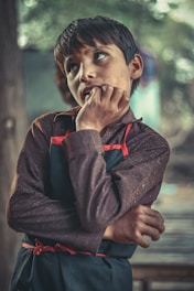 A young adult thoughtfully considering college and trade school options with a mentor.