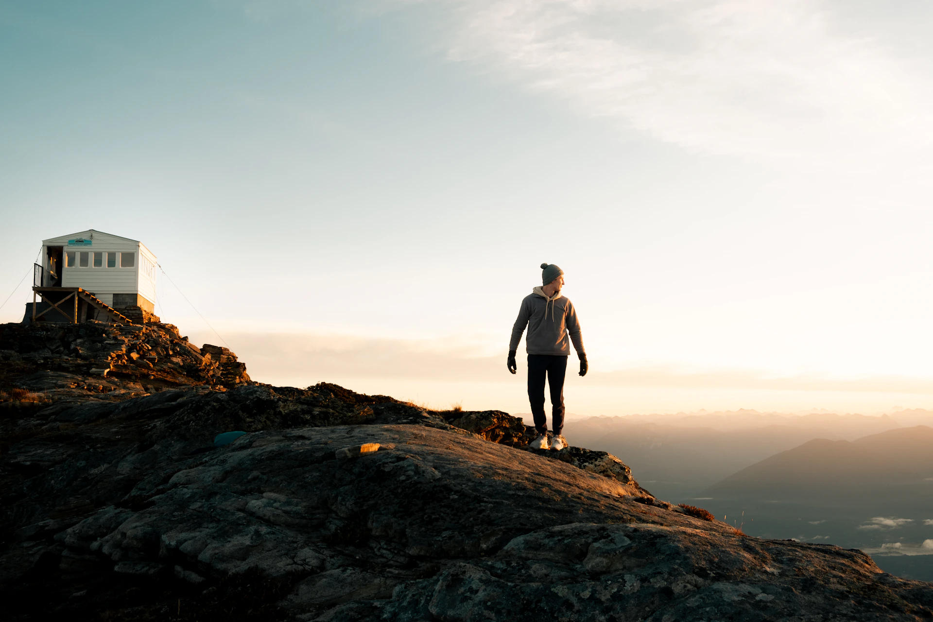 a man standing on top of a rocky hill