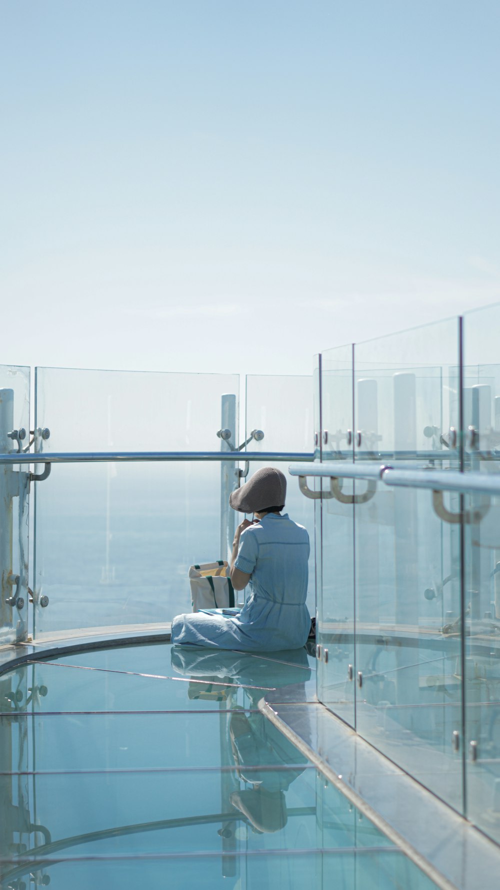 a person sitting on the edge of a swimming pool