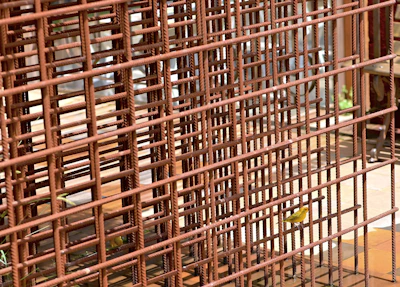 Detail of the barrier surface that prevents birds from perching, with sunlight highlighting its texture.