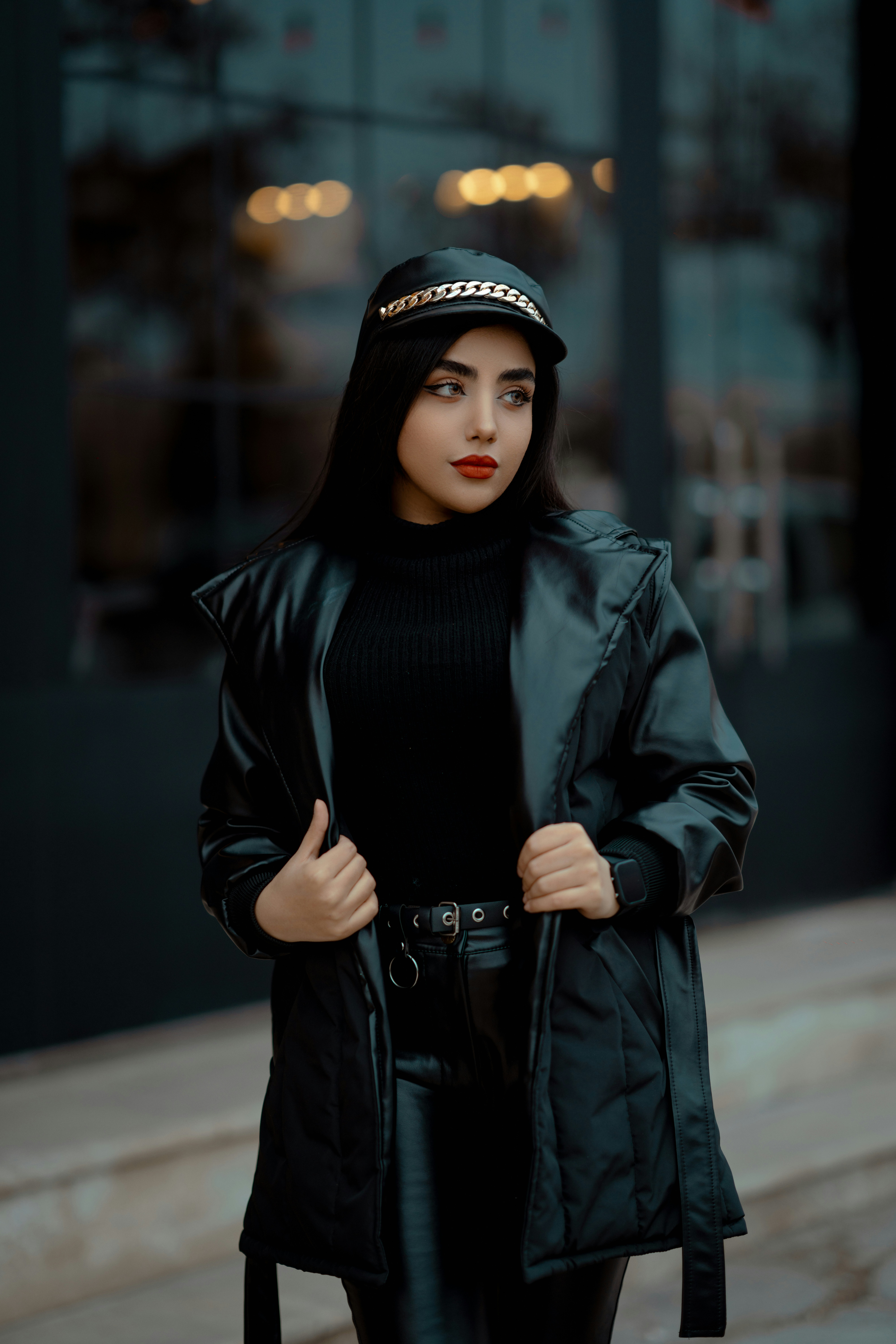 a woman in a black outfit and a black jacket