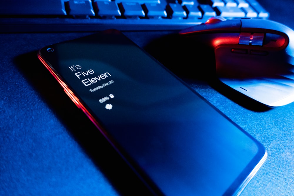 a close up of a cell phone near a keyboard