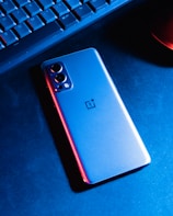 a close up of a cell phone near a keyboard