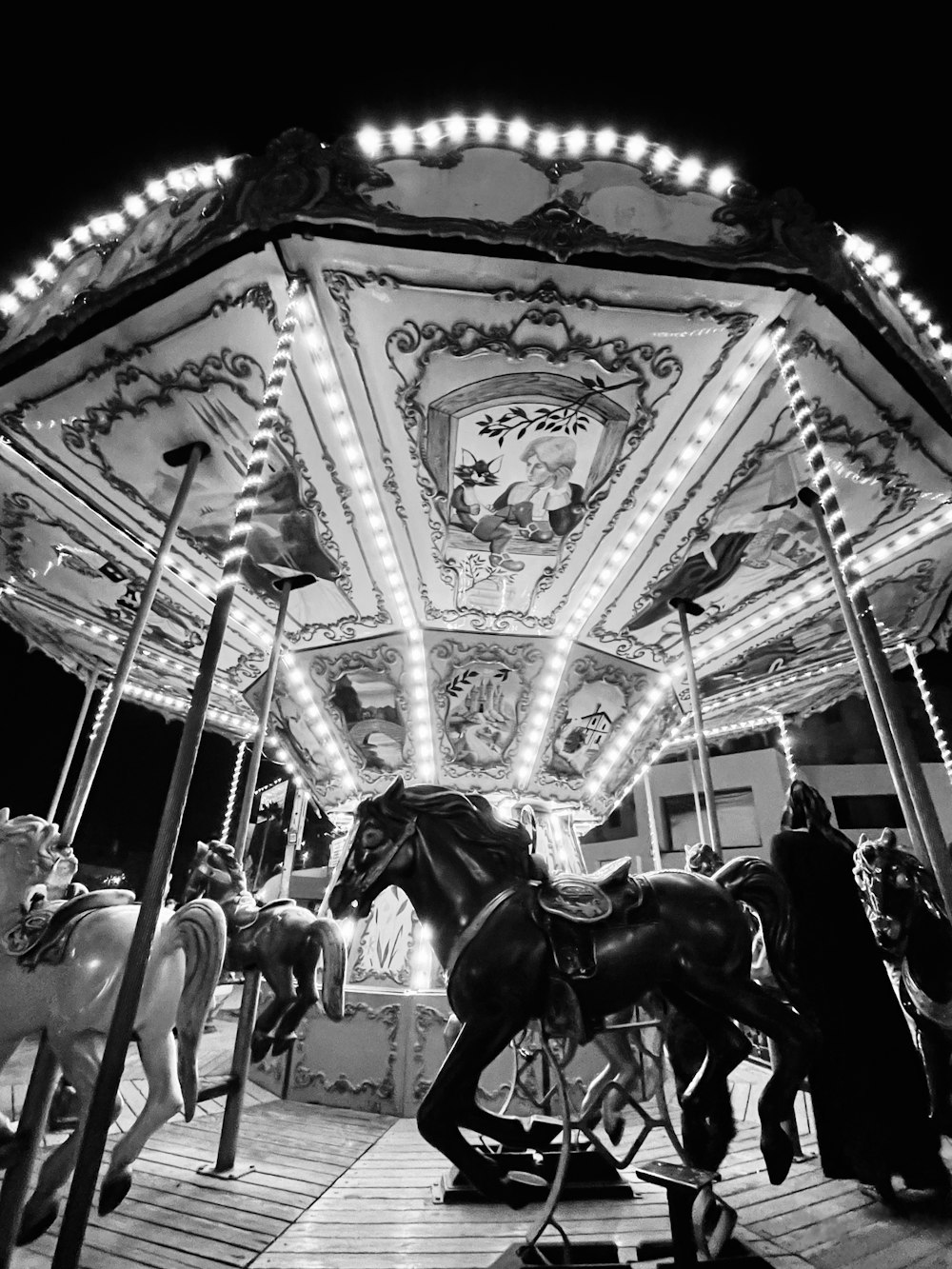 a black and white photo of a merry go round